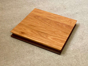 Square cutting and serving board made of white oak on one side and walnut on the reverse. Sculpted edges provide comfortable fingerholds.