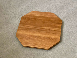 Octagonal shaped cutting and serving board made of white oak. Sculpted edges provide comfortable fingerholds.