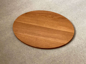 Oval shaped cutting and serving board in white oak. Sculpted edges provide comfortable fingerholds.