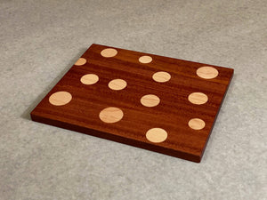 Small rectangular board of mahogany with inlaid polka dots of maple. Pattern is on both sides.